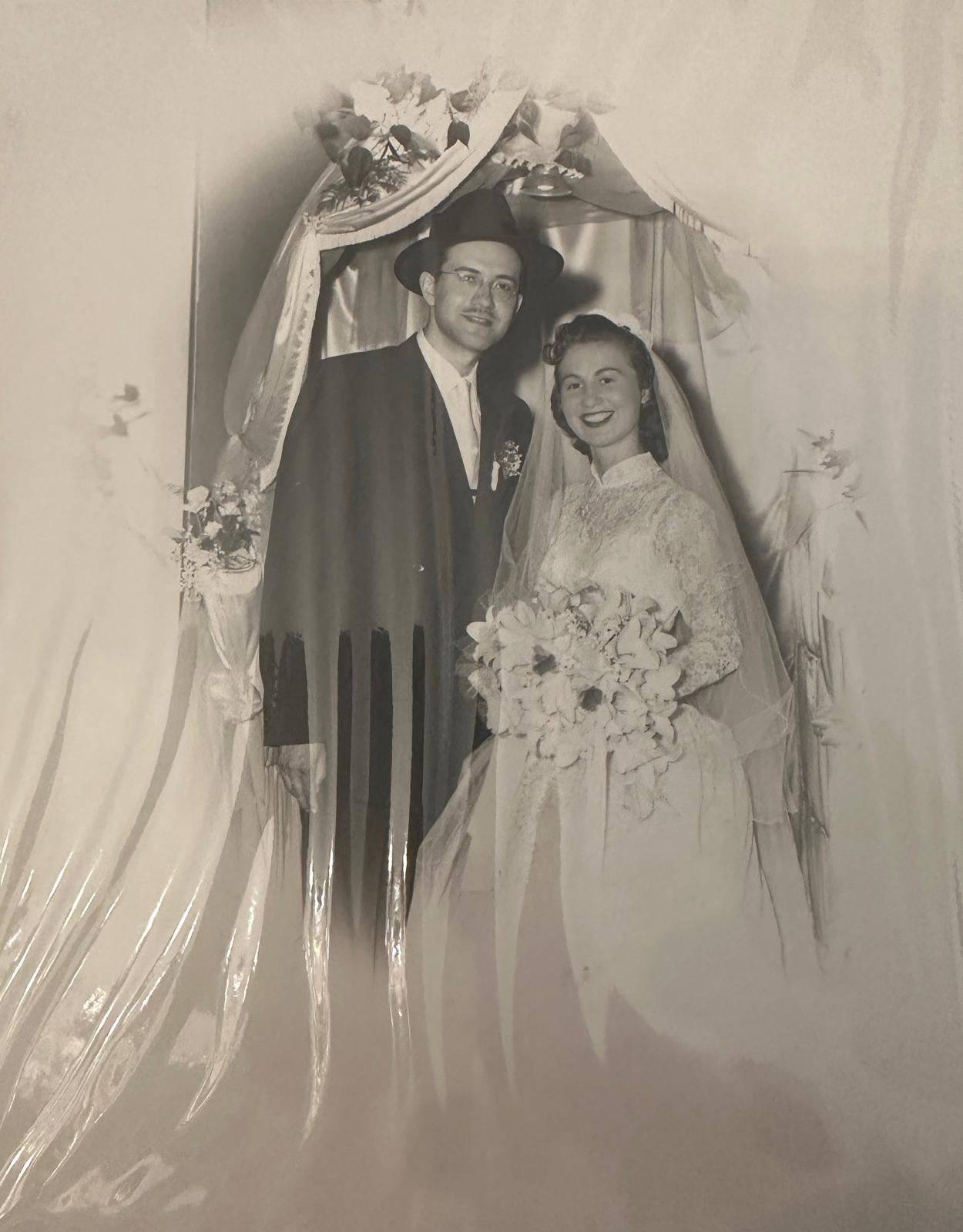 Bobby and Zeidy Rubenstein on their wedding day beneath the chuppah